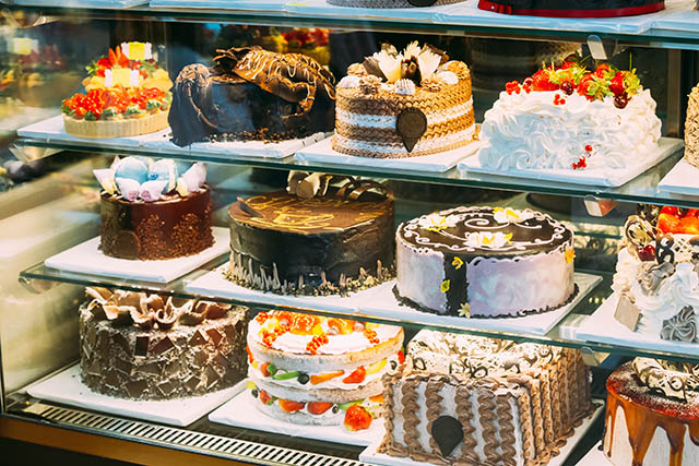 variety of cakes in glass case